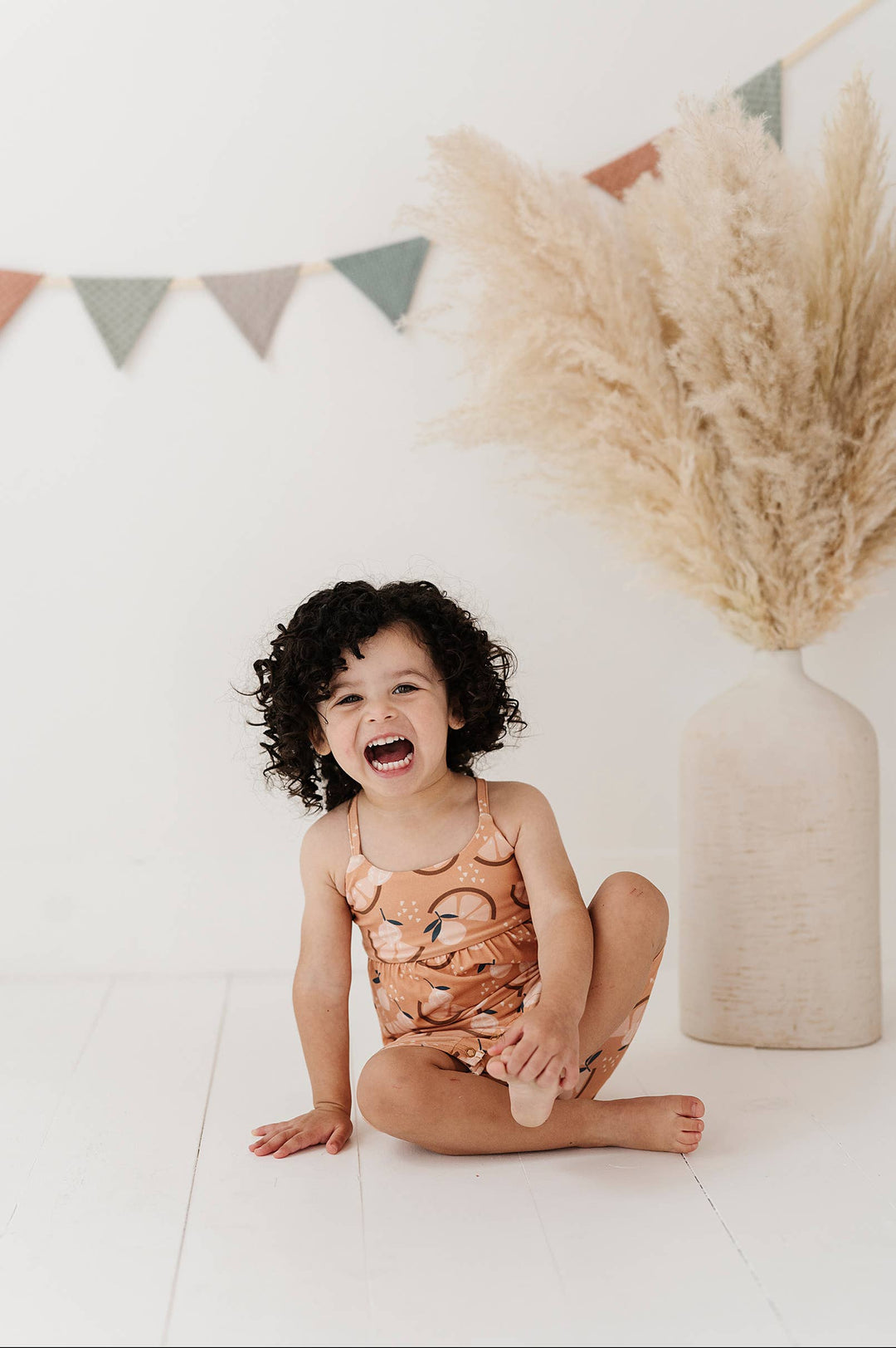 Girl's Tie-Back Romper in Orange Slice